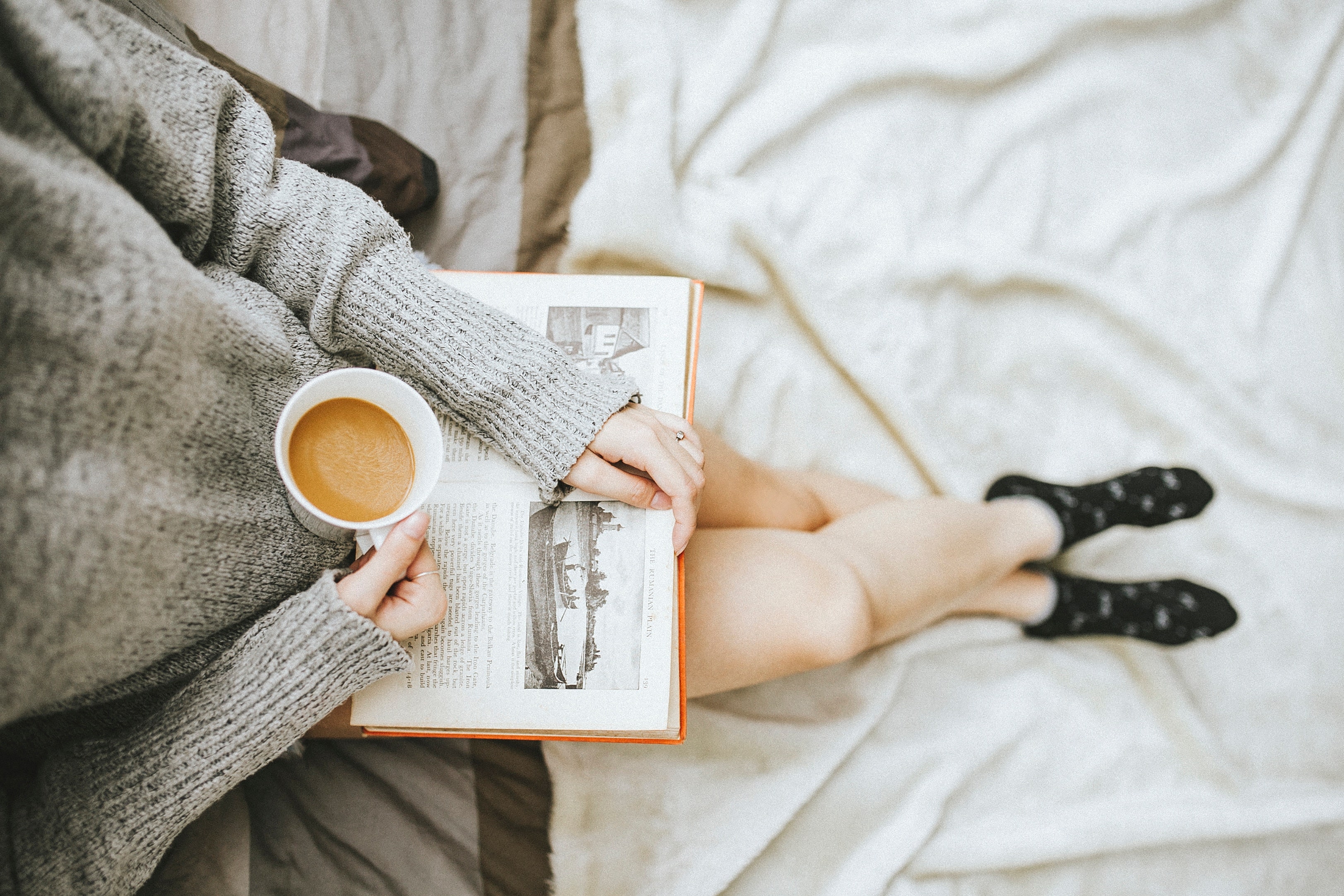 woman reading with a cup of coffee