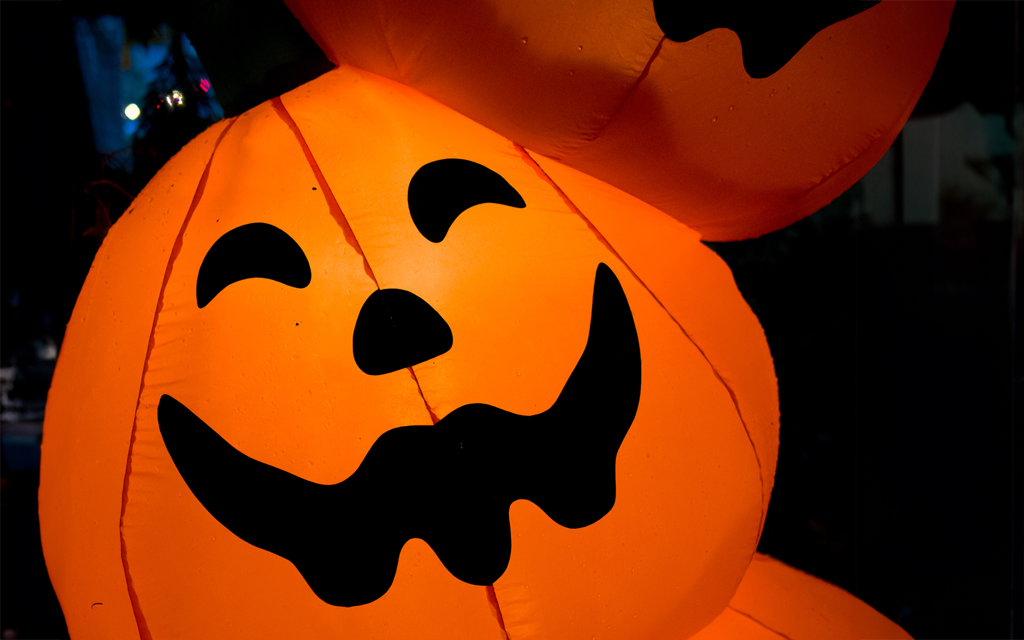 pumpkin totem inflatable decoration at night on front lawn