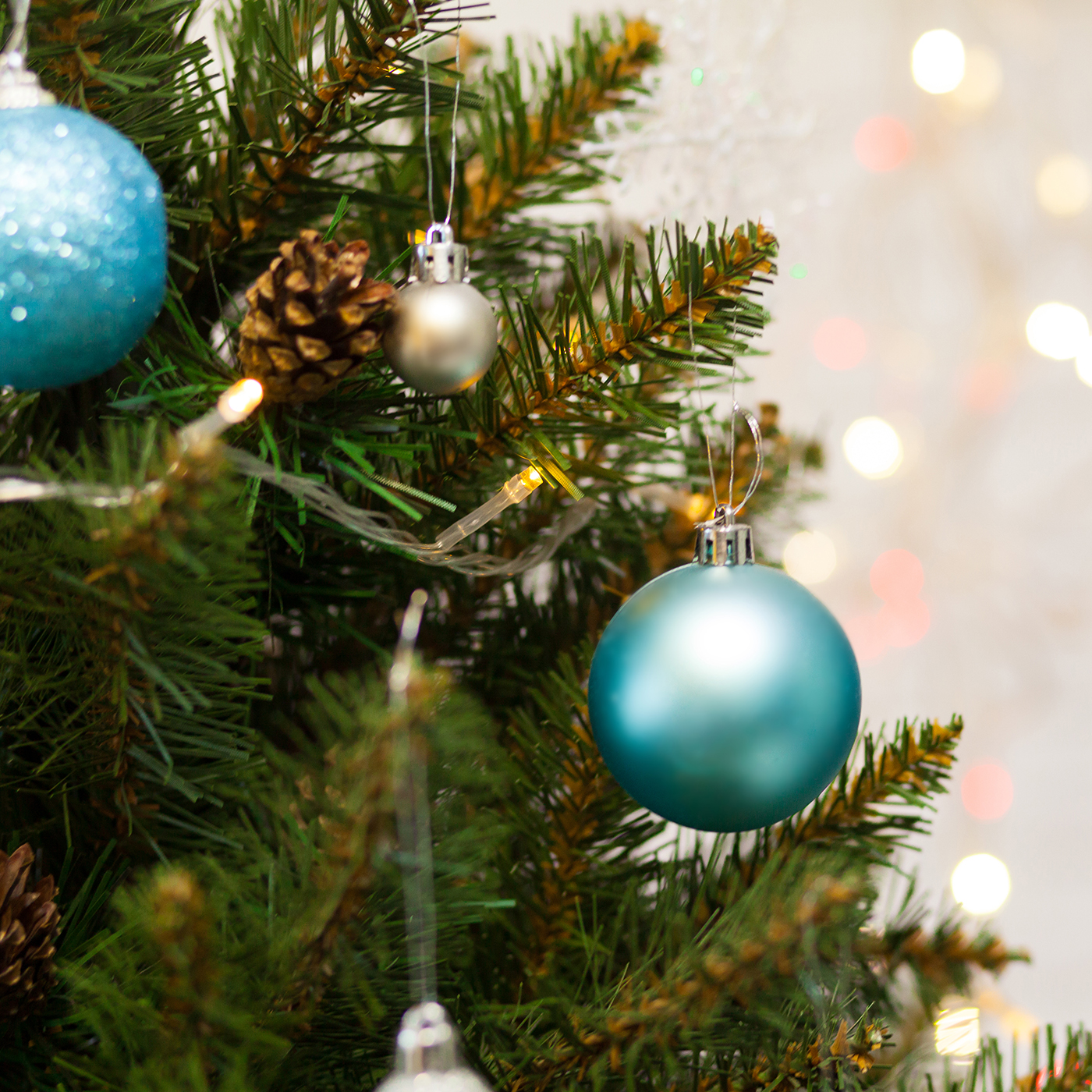 Christmas tree branches with pinecone and blue ornaments